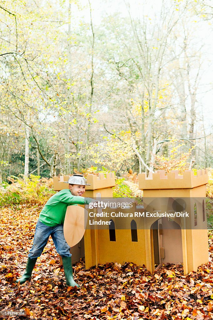 Boy playing with toys in forest