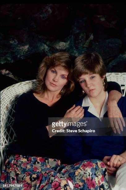 Portrait of American actress Priscilla Presley and her daughter, Lisa Marie Presley, as they sit together on a wicker sofa, Los Angeles, California,...