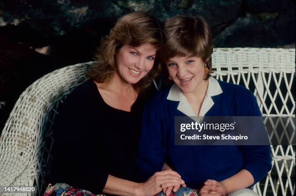 Portrait of American actress Priscilla Presley and her daughter, Lisa Marie Presley, as they sit together on a wicker sofa, Los Angeles, California,...