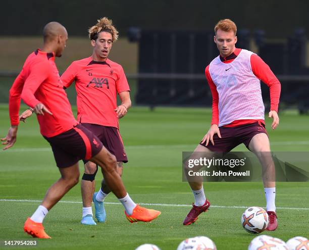 Fabinho, Kostas Tsimikas and Sepp van den Berg of Liverpool during a training session at AXA Training Centre on August 25, 2022 in Kirkby, England.