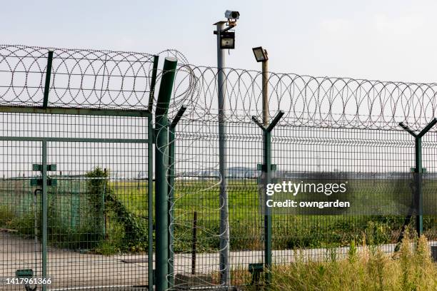 low angle view of barbed wire against sky airplane aircraft - prison bars stock pictures, royalty-free photos & images