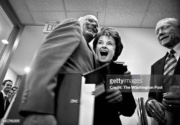 Sen. Dianne Feinstein is embraced by Sen. Patrick J. Leahy , left, before an Amber Alert press conference outside the doors of the Senate Radio and...