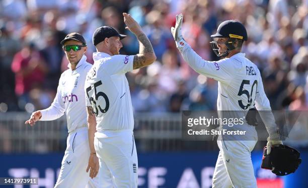 England captain Ben Stokes congratulates wicketkeeper Ben Foakes during day one of the second test match between England and South Africa at Old...