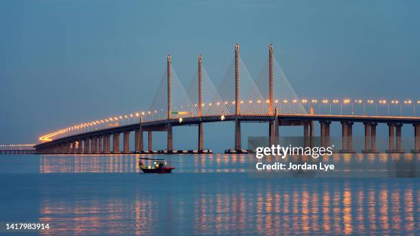 penang bridge and a fishing boat - penang state stock pictures, royalty-free photos & images