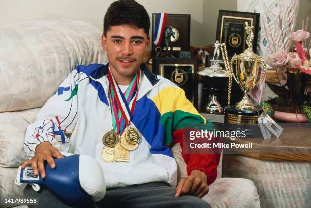 Boxer Oscar De La Hoya of the United States poses for photograph with his boxing medals and trophies at his family home on South McDonnell street on...
