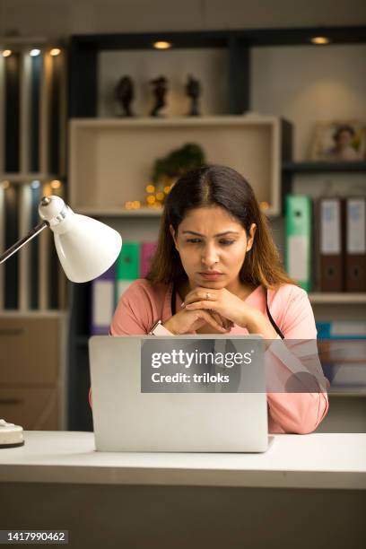 thoughtful businesswoman using laptop at home - it problems stock pictures, royalty-free photos & images