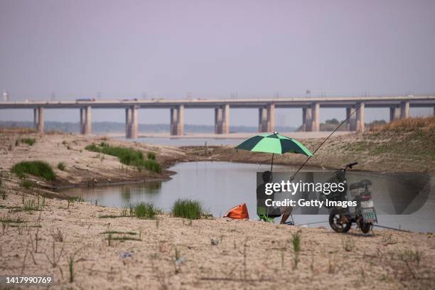 Man seen fishing on the beach of the Yangtze River on August 25, 2022 in Wuhan, Hubei Province, China. Since July the continuous high temperature has...