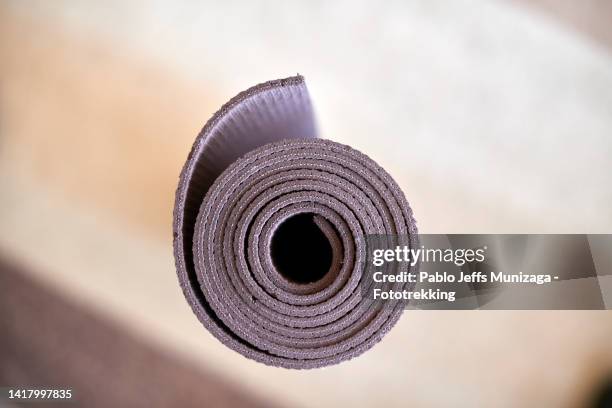 yoga mat rolled up seen from above - mat stock-fotos und bilder