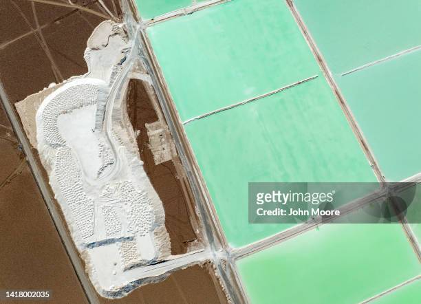 In this aerial view, a pool of brine containing lithium carbonate and a mound of salt bi-product lie atop a lithium mine in the Atacama Desert on...