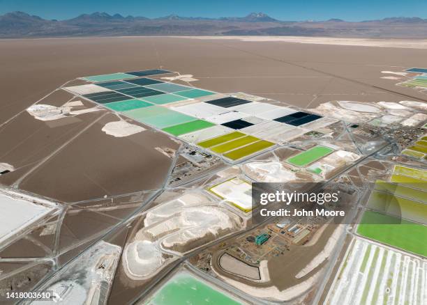 In this aerial view, pools of brine containing lithium carbonate and mounds of salt bi-product stretch across a lithium mine in the Atacama Desert on...