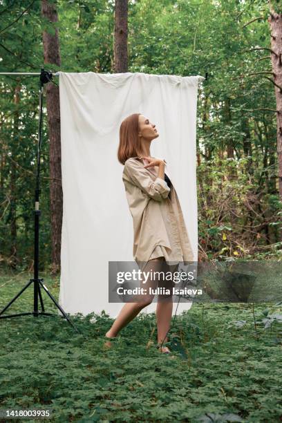 trendy woman during photo shoot in forest - daylight saving time 2021 stock pictures, royalty-free photos & images