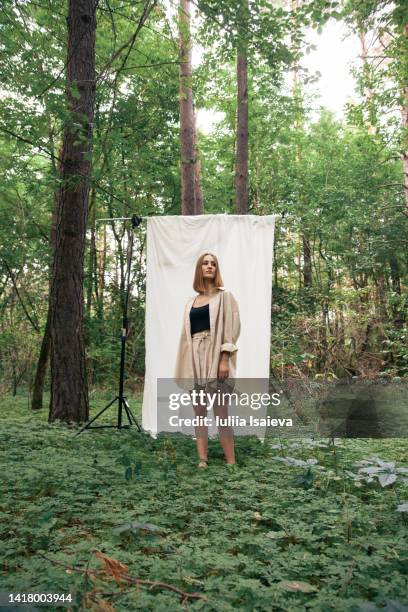 trendy woman during photo shoot in forest - daylight saving time 2021 stock pictures, royalty-free photos & images