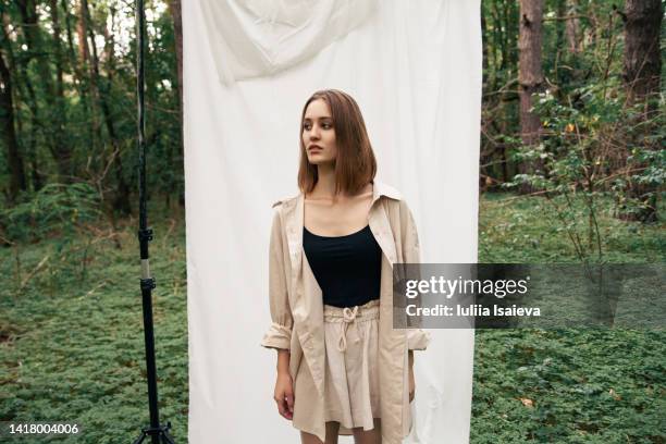 trendy woman during photo shoot in forest - daylight saving time 2021 stock pictures, royalty-free photos & images