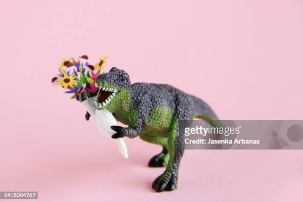 a dinosaur in love - toy animal stock photos et images de collection