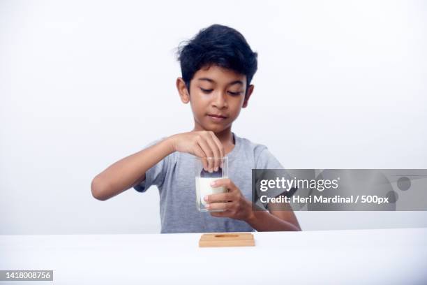 children eat breakfast and drink fresh milk,bali,indonesia - heri mardinal stock pictures, royalty-free photos & images