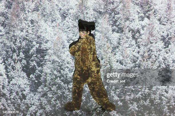 female in bear costume standing in snow forest - snow in tokyo ストックフォトと画像