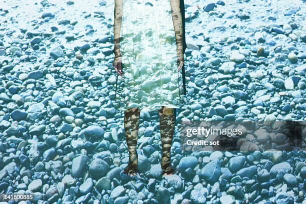 female standing in many stones of the beach - backdrop projection of beach stock pictures, royalty-free photos & images