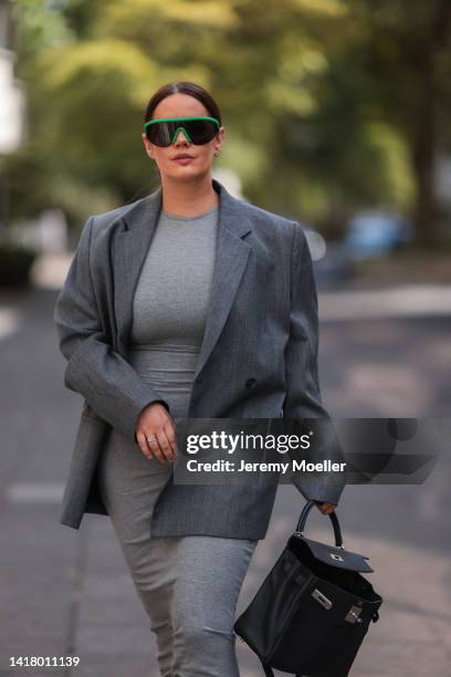 Julia Zwingenberg wearing Bottega Veneta black and green shades, Acne Studios grey oversized blazer, grey long Skims cotton dress, Hermes black...