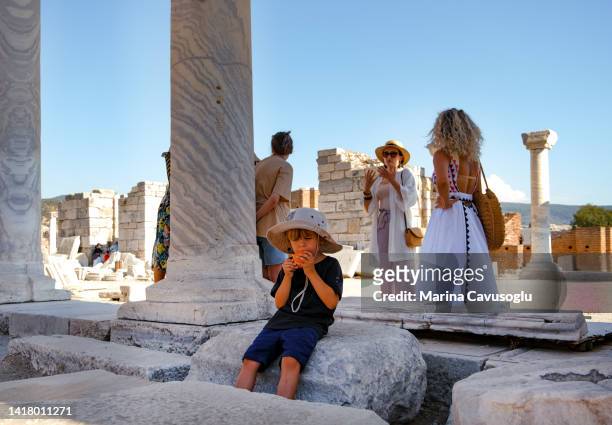 group of tourists with a child listening to the guide in ancient greek museum. - museum guide stock-fotos und bilder