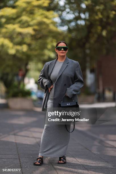 Julia Zwingenberg wearing Bottega Veneta black and green shades, Acne Studios grey oversized blazer, grey long Skims cotton dress, Hermes black...