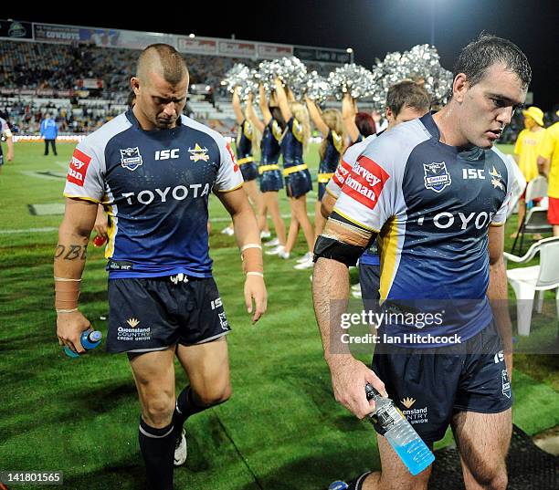 Ashton Sims and Kane Linnett of the Cowboys walk off the field after losing the round four NRL match between the North Queensland Cowboys and the...