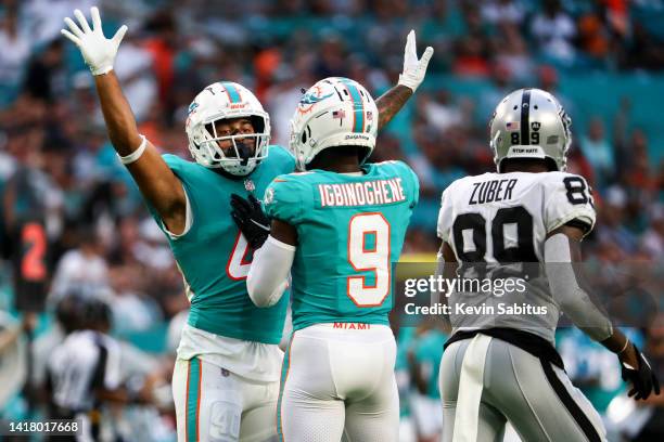 Nik Needham of the Miami Dolphins celebrates with Noah Igbinoghene after a play during a preseason NFL football game against the Las Vegas Raiders at...