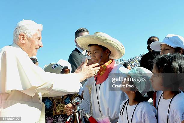 Pope Benedict XVI is welcomed by children upon his arrival at Silao's international airport on March 24, 2012 in Guanajuato, Mexico. After visiting...