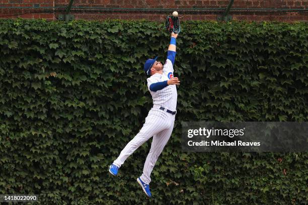 Ian Happ of the Chicago Cubs catches a ball hit by Nolan Gorman of the St. Louis Cardinals during the third inning at Wrigley Field on August 25,...