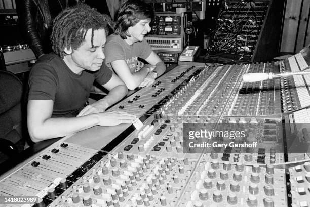 View of American Rock & Blues musician Garland Jeffreys and producer Bob Clearmountain as they sit at a mixing board in the control room at the Power...