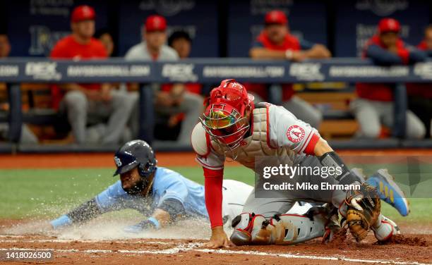 Manuel Margot of the Tampa Bay Rays slides into home as Kurt Suzuki of the Los Angeles Angels fields the throw in the fifth inningduring a game at...