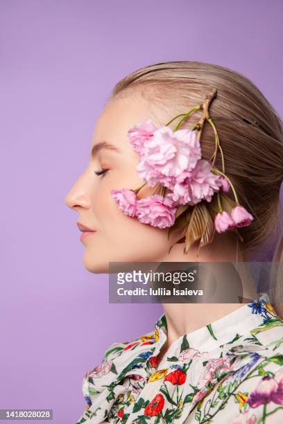 female model with flower petals near face - floral blouse stock pictures, royalty-free photos & images