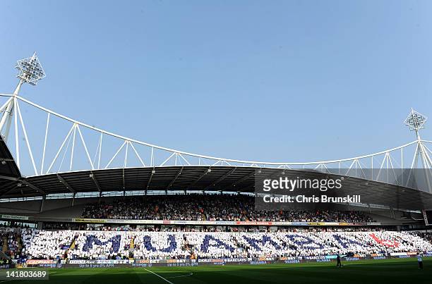 Fans in the East Stand Lower hold up a tribute to Fabrice Muamba during the Barclays Premier League match between Bolton Wanderers and Blackburn...