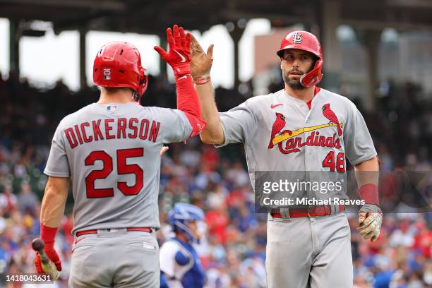 Paul Goldschmidt of the St. Louis Cardinals high fives Corey Dickerson after hitting a two-run home run during the eighth inning against the Chicago...