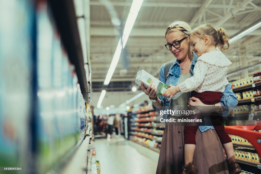 Mom and Daughter Shopping Together in the Supermarket