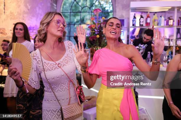 Monica Meier Ivancan and Jana Ina Zarrella dance at the Jana Ina Zarrella X Eyes + More glasses launch event at Harbour Club Köln on August 25, 2022...