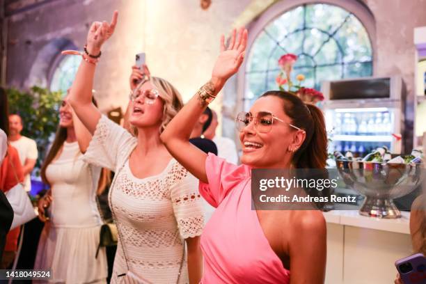 Monica Meier Ivancan and Jana Ina Zarrella dance at the Jana Ina Zarrella X Eyes + More glasses launch event at Harbour Club Köln on August 25, 2022...