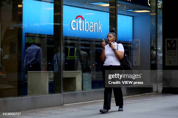 Woman walks near a Citibank branch on August 25, 2022 in New York City. Citigroup Inc. Will begin to close consumer and local commercial banking...