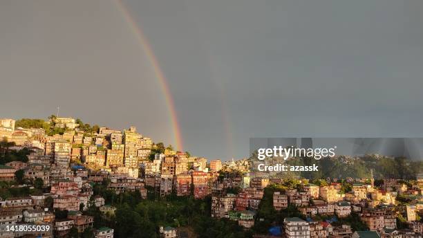 rainbow as seen over the cityscape - mizoram india stock pictures, royalty-free photos & images