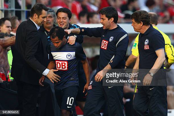 Raffael of Berlin celebrates with manager Michael Preetz, assistant coaches Ante Covic and Rene Tretschok and head coach Otto Rehhagel during the...