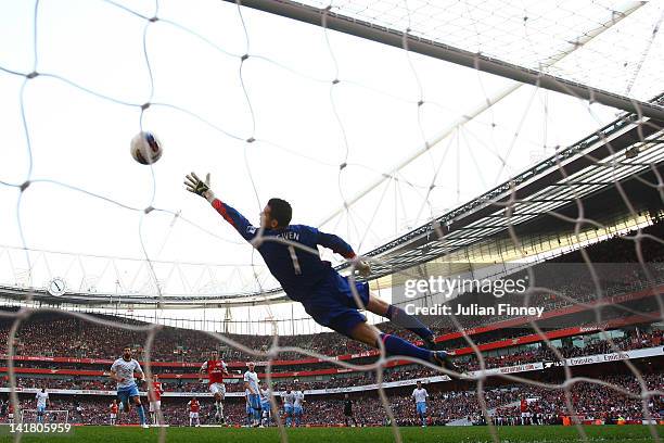 Shay Given of Aston Villa fails to stop Mikel Arteta of Arsenal's free kick during the Barclays Premier League match between Arsenal and Aston Villal...