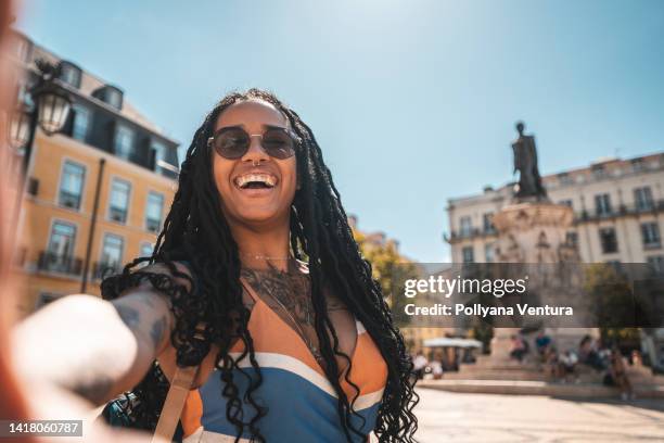 woman taking a selfie in lisbon - tinted eyeglasses stockfoto's en -beelden