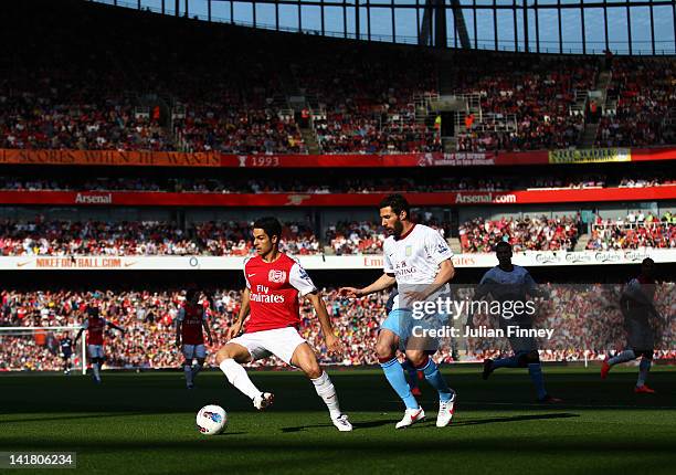 Mikel Arteta of Arsenal and Carlos Cuellar of Aston Villa compete for the ball during the Barclays Premier League match between Arsenal and Aston...