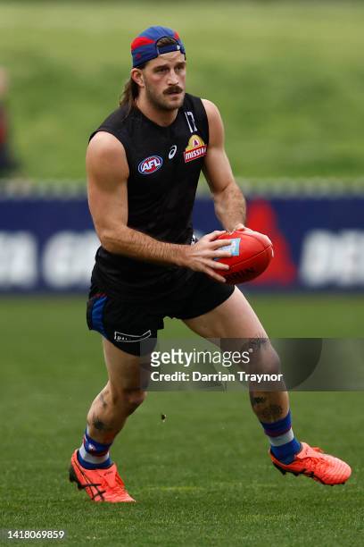 Josh Bruce runs with the ball during a Western Bulldogs AFL training session at ETU Stadium on August 26, 2022 in Melbourne, Australia.