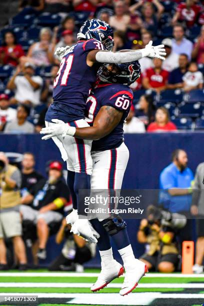 Dameon Pierce celebrates with A.J. Cann of the Houston Texans after scoring a touchdown in the first quarter against the San Francisco 49ers during a...