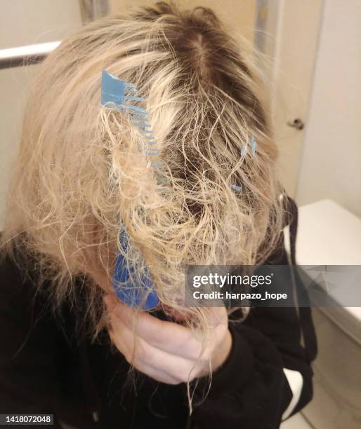 girl with comb stuck in her tangled hair. - child pulling hair stock pictures, royalty-free photos & images
