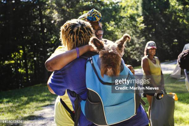 friends hug as they arrive to get ready for hiking trail - "marilyn nieves" stock pictures, royalty-free photos & images