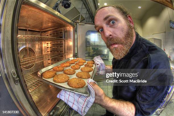 portrait of man with cookies - scott macbride stock pictures, royalty-free photos & images