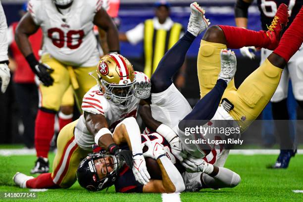 Rex Burkhead of the Houston Texans is tackled by Marcelino McCrary-Ball of the San Francisco 49ers in the second quarter during a preseason game at...