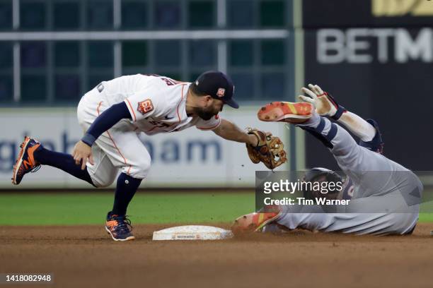 Jose Altuve of the Houston Astros tags Jose Miranda of the Minnesota Twins out at second in the sixth inning at Minute Maid Park on August 25, 2022...
