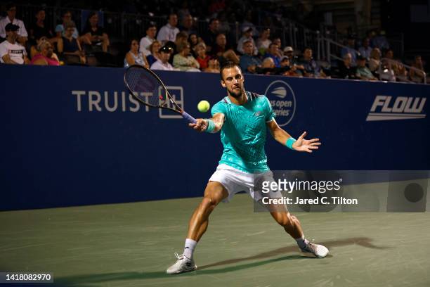 Laslo Djere of Serbia returns a shot from Richard Gasquet of France during their quarterfinals match on day six of the Winston-Salem Open at Wake...